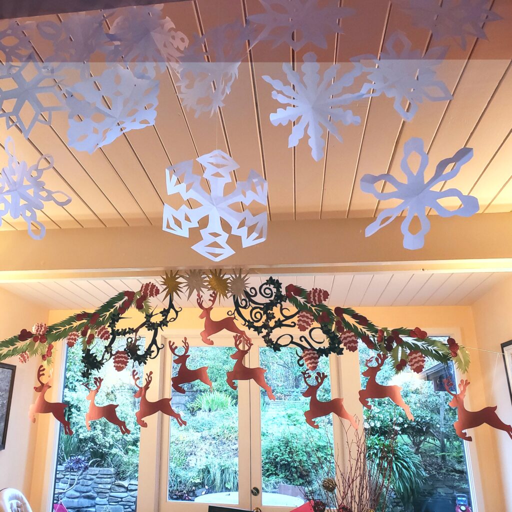 A beautiful festive tableau of reindeer, pine cones and snow flakes made just using paper by my talented sister in law